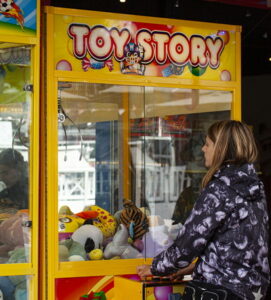 arcade claw grabber game lady playing