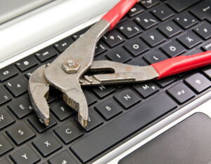 computer keyboard with wrench on top