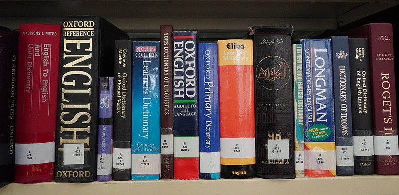 dictionaries on a book shelf