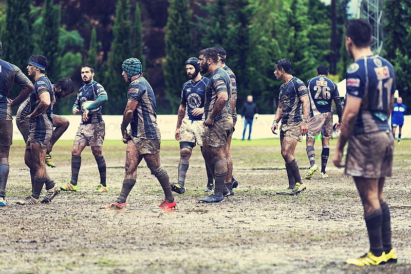rugby match on a muddy pitch