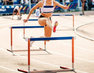 althletics hurdler running on a hot day