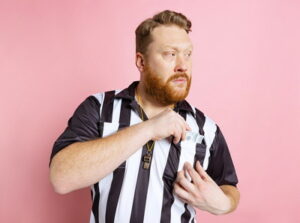 referee shoving money in pocket