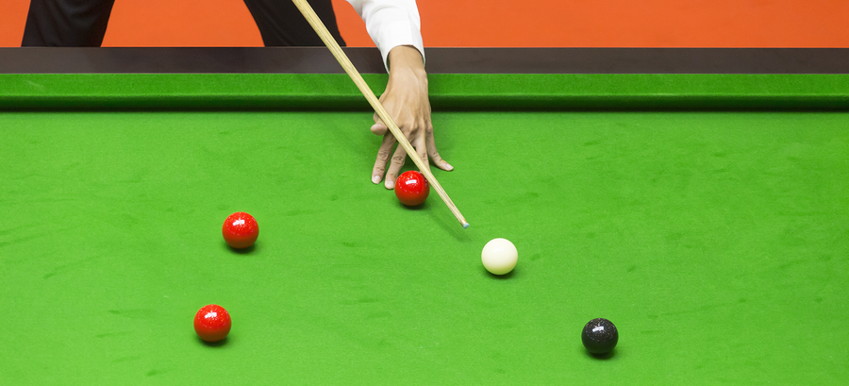 snooker player taking a shot at the black
