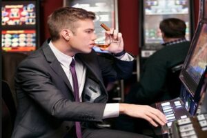 Man Drinking Playing Slot Machine